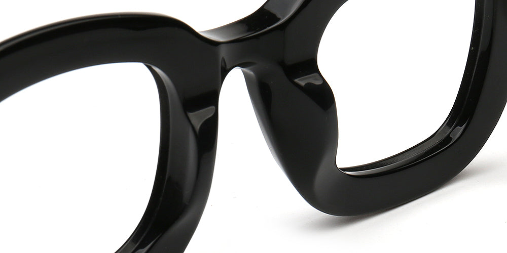 Close-up of a black eyeglasses frame on a white background