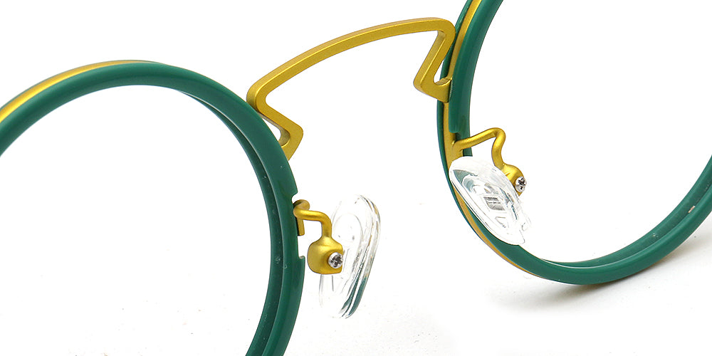 Close-up of green and gold eyeglasses on a white background