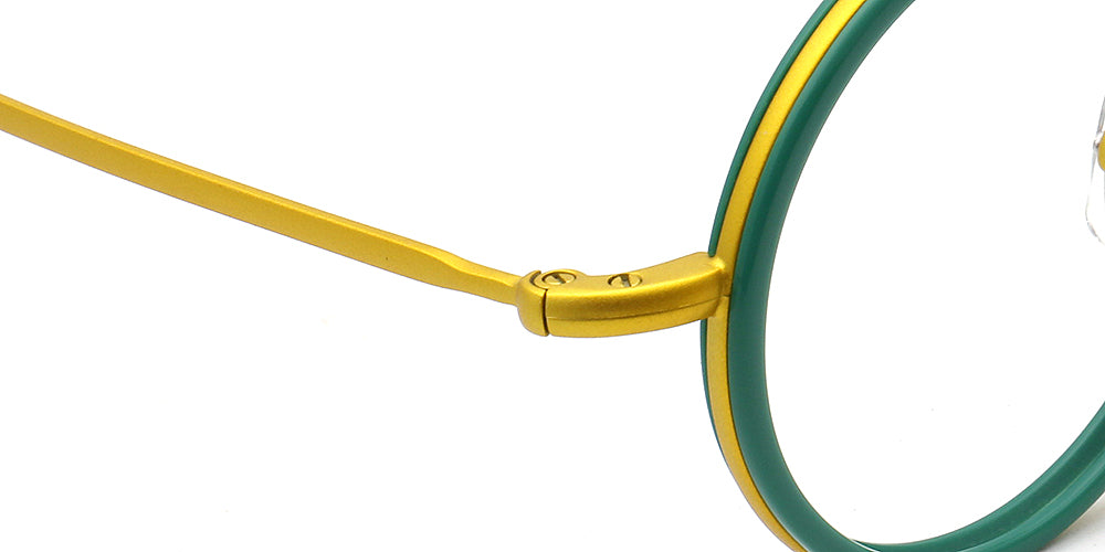 Close-up of eyeglasses with gold frame and green lenses on a white background