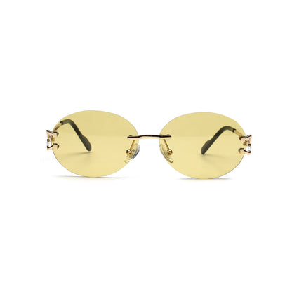 Yellow tinted round rimless sunglasses with gold temples front view