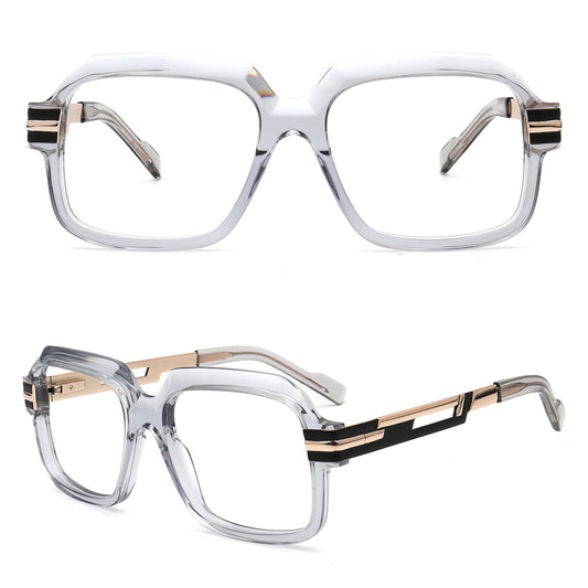 a pair of oversized square eyeglasses with a translucent grey frame, rose gold metal accents, and black temple tips