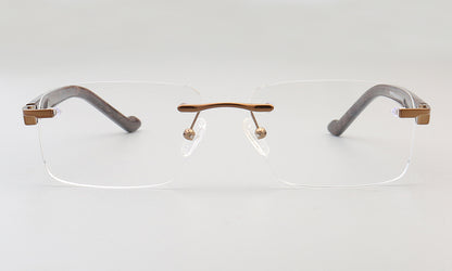 A pair of bronze rimless rectangular eyeglass frames