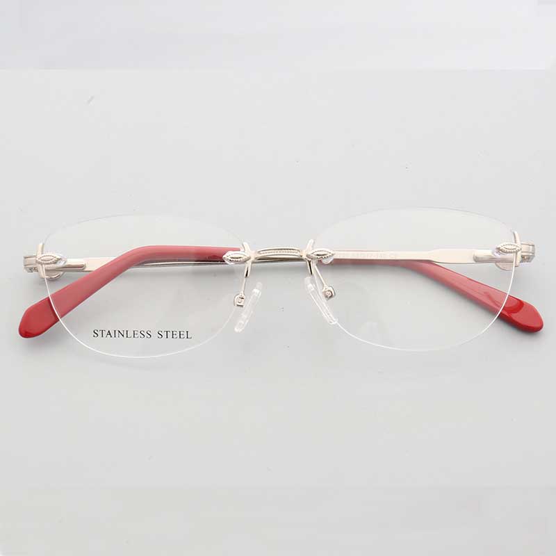 Front view of silver and red oval rimless eyeglass frames