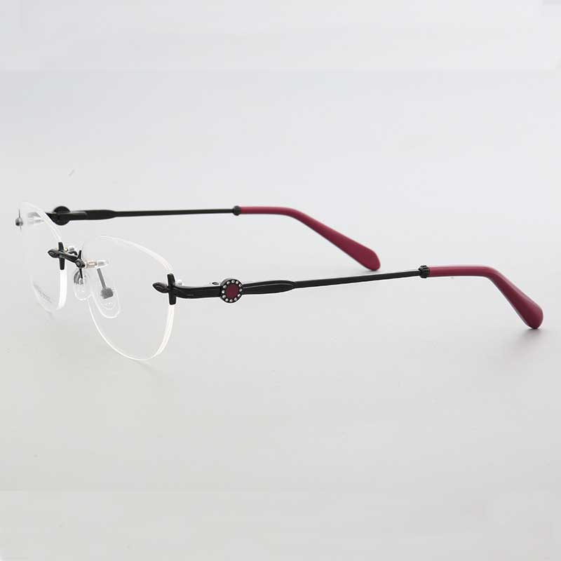 Side view of black and pink oval rimless eyeglass frames