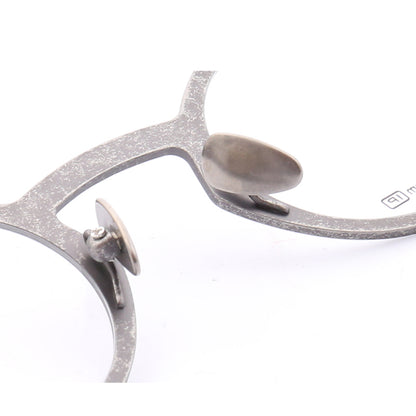 Nose pads of grey titanium eyeglass frames