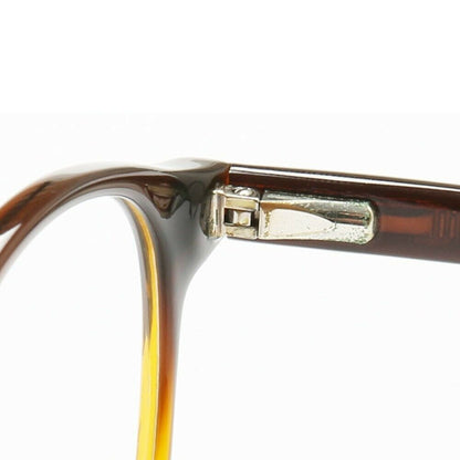Hinge of round caramel colored glasses frames